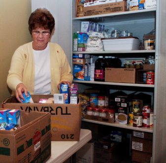 W.A. Mallett School nurse Katie Hallman sorts foods that are available to students and families in the pantry she organized at the Farmington school.