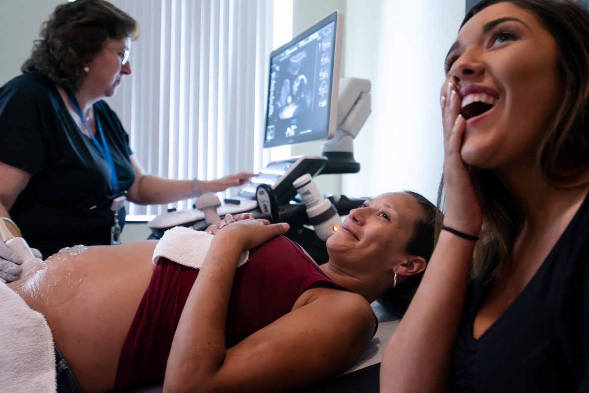 Jessica Coulombe and her 19-year-old daughter McKenzie joyfully watch the ultrasound image of Jessica's fetus in July at Maine Med. Jessica, in recovery from drug addiction, found out that she was having a girl, her sixth daughter. Photo by Yoon S. Byun.