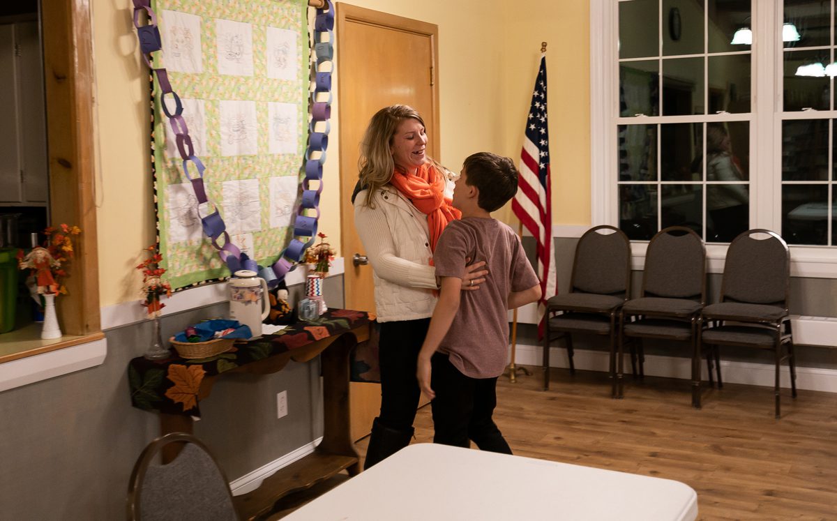 Courtney Allen hugs her older son, Wyatt, before a Young People in Recovery (YPR) meeting at South Parish Congregational Church UCC in Augusta, ME on Tuesday, November 6, 2018. "It's my third birthday," says Allen to her son, which he refutes, and she responds, "It's true. I didn't live until I found recovery." This meeting would be her 3-year anniversary not using drugs. (Photo by Yoon S. Byun)