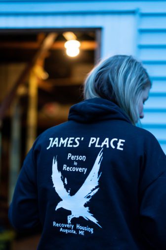 Courtney Allen wears a James' Place sweatshirt on a day she hands out t-shirts and sells sweatshirts to support the recovery home in Augusta, ME on Thursday, November 15, 2018. (Photo by Yoon S. Byun)