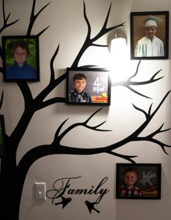 Courtney Allen's family photos of her sons Wyatt and Aimin hang on a wall at her home in Augusta, ME on Thursday, November 15, 2018. Allen moved into the home in early October. (Photo by Yoon S. Byun)