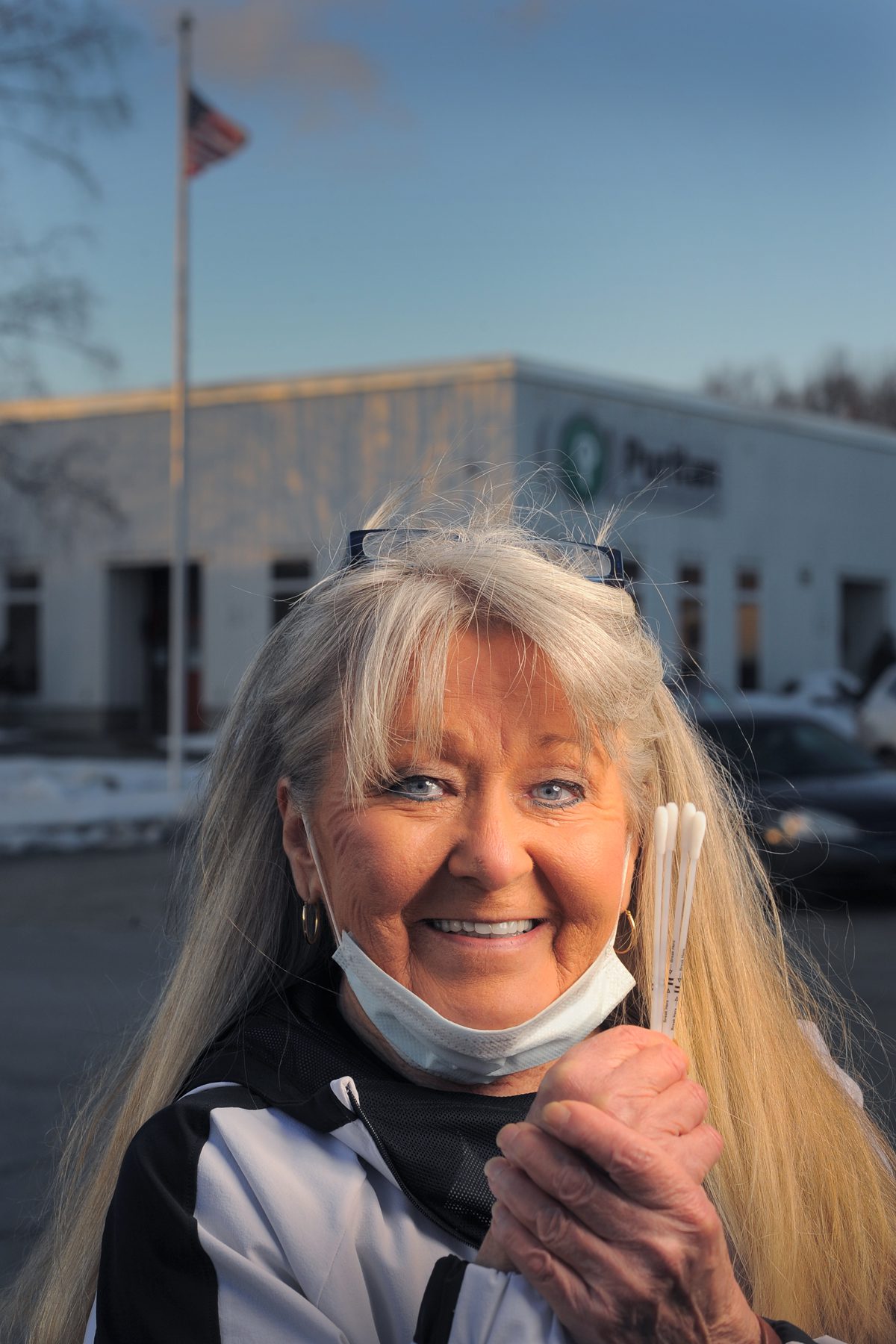 Irene Chase outside Puritan Medical Products building holding swabs