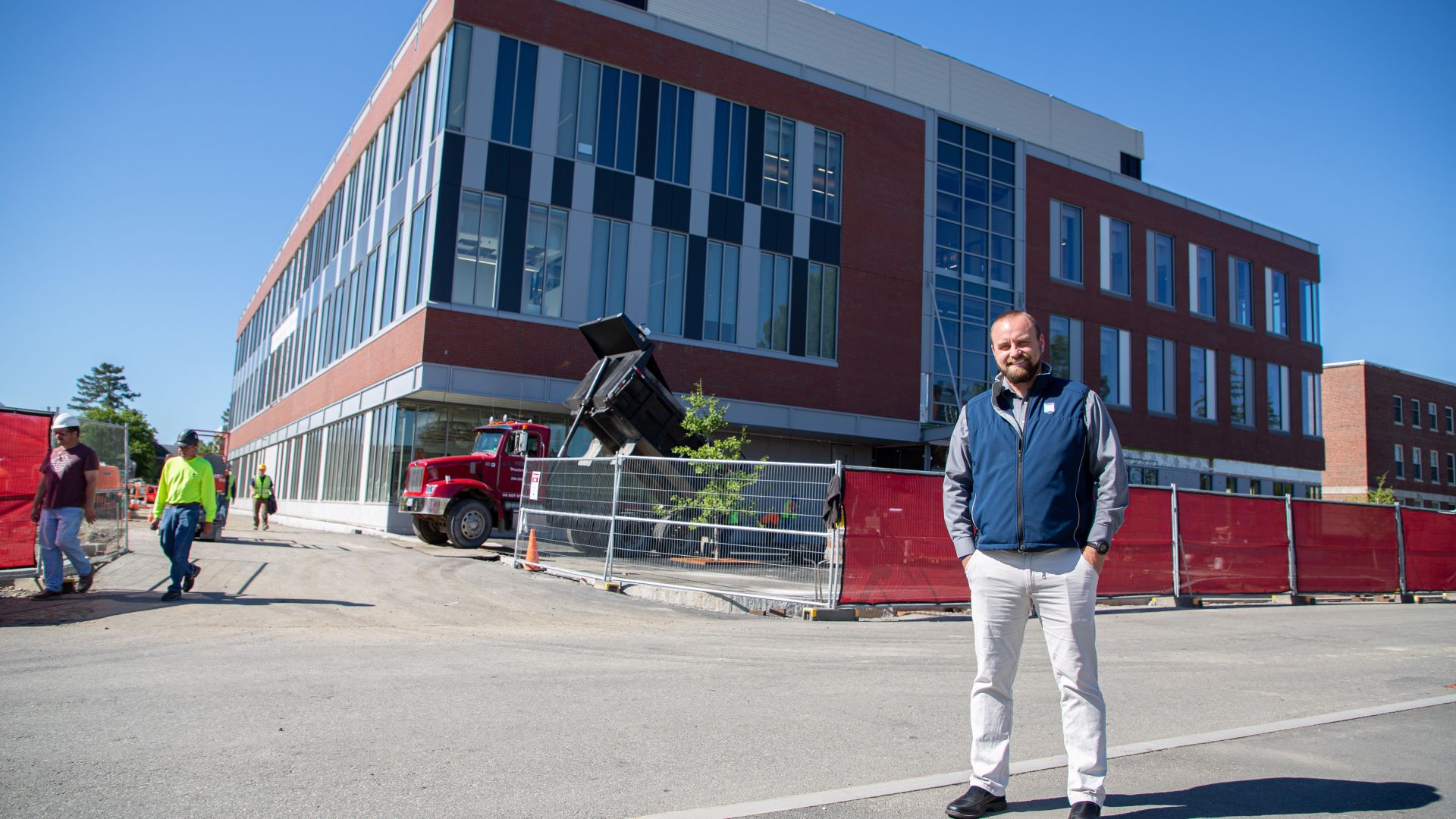 Chris Richards stands in front of the new engineering building at the University of Maine.