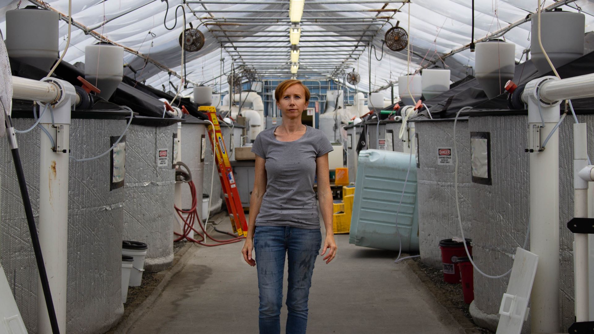 Sara Rademaker stands in her eel facility.