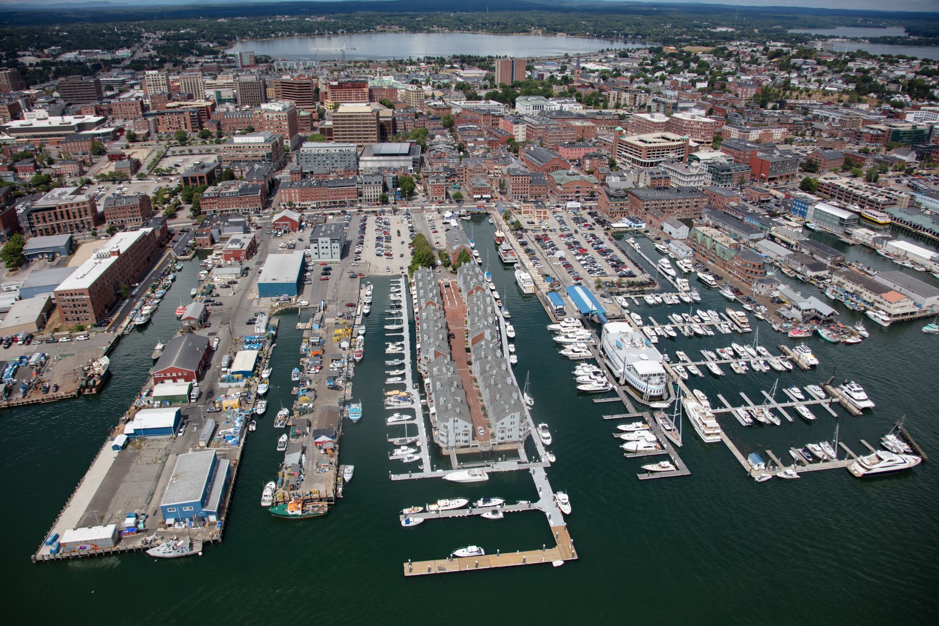 Aerial view of the businesses and parking lots in Portland surrounded by water
