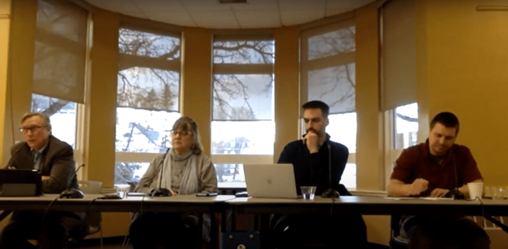 A panel of four speakers representing three Maine nonprofit newsrooms sit at a table.